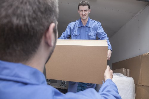 Specialist piano removals team handling an upright piano in Pimlico