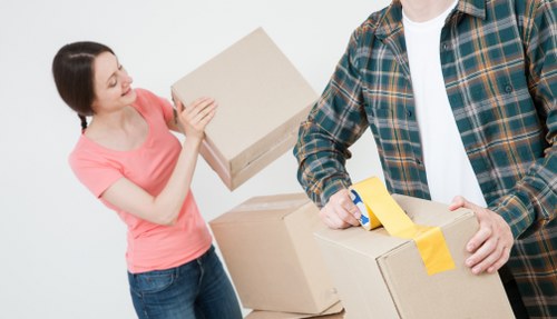 Staff wearing PPE while loading furniture into a van